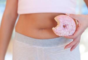 getty_rf_photo_of_woman_holding_donut