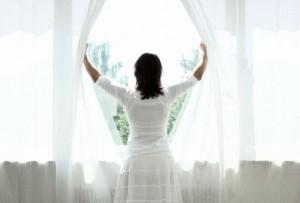 getty_rm_photo_of_woman_opening_curtains